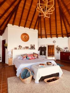 a bedroom with a large bed and a wooden ceiling at LasNubes EcolodgeNubes Ecolodge in Santa Elena +54 photos
