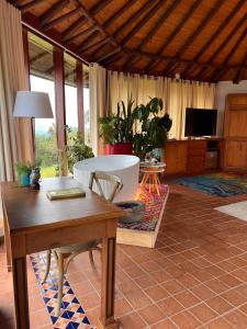 a living room with a table and a tub in it at Cabaña en Santa Elena con vista a Medellín in Santa Elena