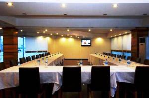 a conference room with tables and chairs and a television at Expo Park Hotel in Antalya