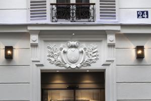 a front door of a building with a sign on it at Le Mireille in Paris