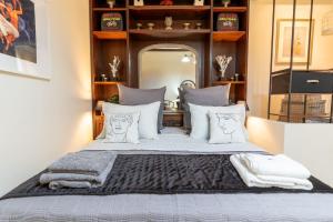 a bedroom with a large bed with white pillows at Vaios Art Residence in Athens