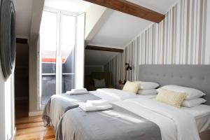 מיטה או מיטות בחדר ב-Flores Guest House