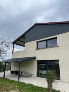 a house with a bench in front of it at Gites de Landuzière in Étrat