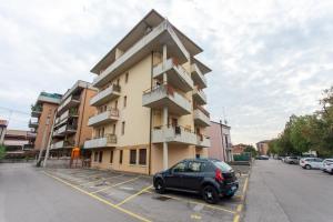 a car parked in a parking lot in front of a building at Harmonie House in Verona