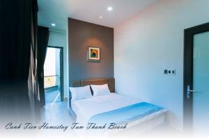a bedroom with a bed and a window at Canh Tien Homestay Tam Thanh Beach in Tam Ky