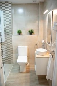 a bathroom with a toilet and a sink at Torneo 48 Suite in Seville