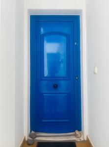 a blue door in a room with a white wall at Apartamento Vista Famara 2 in Famara +1 photo