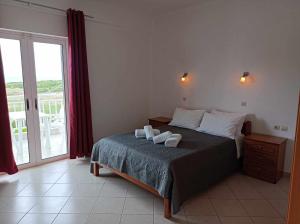 a bedroom with a bed with two white dishes on it at Kipriotis Hotel in Arkoudi +100 photos