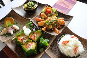 a table with three plates of food and rice at Khemara Angkor Hotel & Spa in Siem Reap