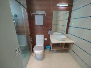 コタキナバルにあるAzumi Retreatのトイレ、洗面台、シャワー付きのバスルーム +4枚の写真