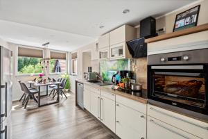 a kitchen with a large oven and a table at Harzquelle - Harzauszeit 2-4 Personen mit Garten in Thale