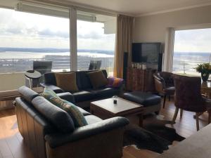 a living room with couches and a large window at Queen Mary Maritim Residenz Travemünde in Lübeck
