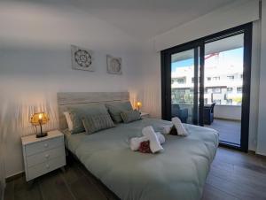 a bedroom with a large bed with two pillows on it at Poolside 2BR apartment Villamartin in Alicante +44 photos