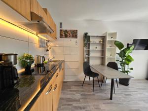 a kitchen with a table and a table and chairs at MsApartment Stylish wohnen in STUTTGART in Stuttgart