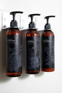 a group of three shampoo bottles sitting next to each other at Nantra Sukhumvit 39 in Bangkok +22 photos