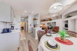 a kitchen and a living room with a table and chairs at Stunning 3 Bed Former Model Home in Orlando