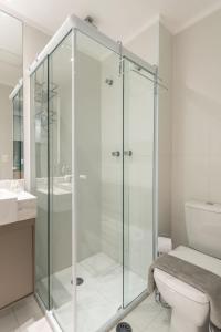 a glass shower in a bathroom with a toilet at Studio na V. Clementino, decorado e aconchegante in Sao Paulo