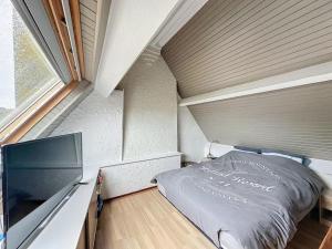 a small bedroom with a bed and a large window at L 'évasion in Le Portel
