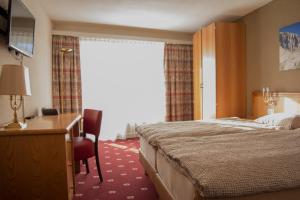 Ένα ή περισσότερα κρεβάτια σε δωμάτιο στο Alpine Classic Hotel