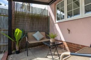 a patio with a chair and a table on a patio at Dickenson in Colchester +10 photos