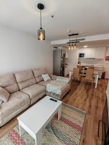 a living room with a couch and a table at Rivas Futura in Rivas-Vaciamadrid