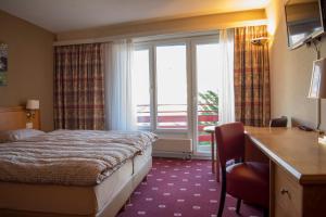 Ένα ή περισσότερα κρεβάτια σε δωμάτιο στο Alpine Classic Hotel