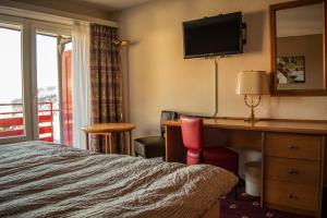 Ένα ή περισσότερα κρεβάτια σε δωμάτιο στο Alpine Classic Hotel