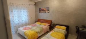 a bedroom with two beds and a window at Casa Melo in Ciampino