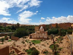 an old building in the middle of a desert at Riad Taourirte in Tinerhir