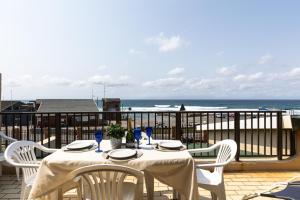 a table on a balcony with a view of the ocean at Eden Dunes 68 in Shelly Beach