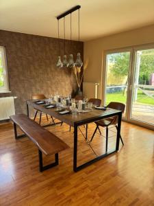 a dining room with a table with chairs and a dining room at Familien Ferienhaus im Grünen in direkter Nähe zum Nürburgring in Kempenich