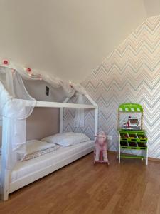 a childs bedroom with a bunk bed and a crib at Familien Ferienhaus im Grünen in direkter Nähe zum Nürburgring in Kempenich