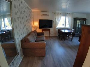 a living room with a couch and a television at Majatalo Varis in Vaala