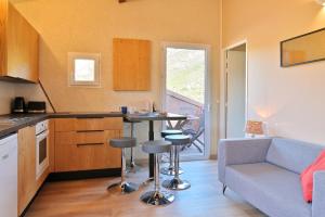 a kitchen with a table and chairs in a room at U Casinu in Piana