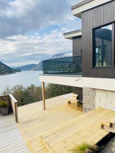 a house with a deck with a view of a lake at Olden Apartment with Panorama view in Olden