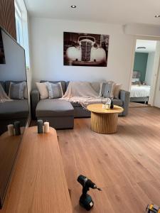 a living room with a couch and a table at luxury Apartment by Skyactive in Tromsø