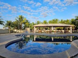 a resort with a swimming pool and a gazebo at Hotel Terceiro Milênio II in Brumado