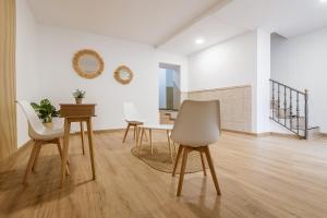 a dining room with two chairs and a table at Doña Norma in Cáceres
