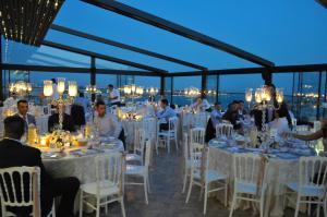 a group of people sitting at tables in a restaurant at Innpera Hotel in Istanbul