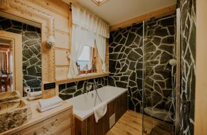 a bathroom with a shower and a tub and a sink at Skyview Apartment in Kościelisko +9 photos