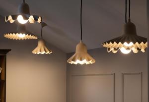 a group of lights hanging from the ceiling at Le Mireille in Paris