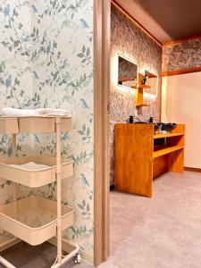 a bathroom with a sink and a desk in a room at 楽心居 in Osaka