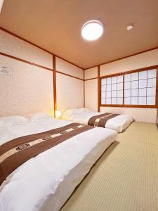 Ένα ή περισσότερα κρεβάτια σε δωμάτιο στο 楽心居 +25 φωτογραφίες