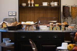 a table with bread and other food items on it at Le Mireille in Paris