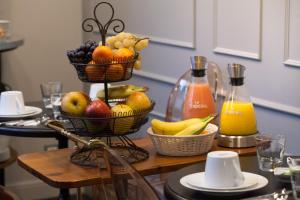 a table topped with baskets of fruit and juice at Le Mireille in Paris