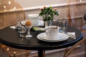 a black table with two cups of coffee on it at Le Mireille in Paris