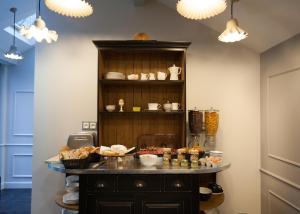 a room with a table with food on it at Le Mireille in Paris