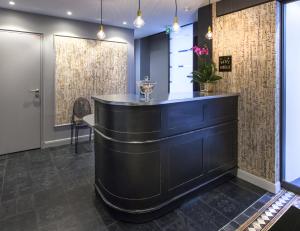 a bar in the lobby of a building at Le Mireille in Paris