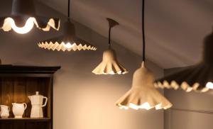 a group of lights hanging from a ceiling at Le Mireille in Paris