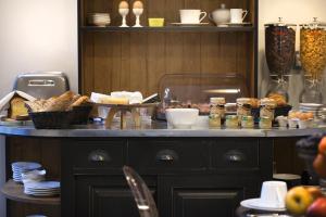 a table with bread and other food items on it at Le Mireille in Paris